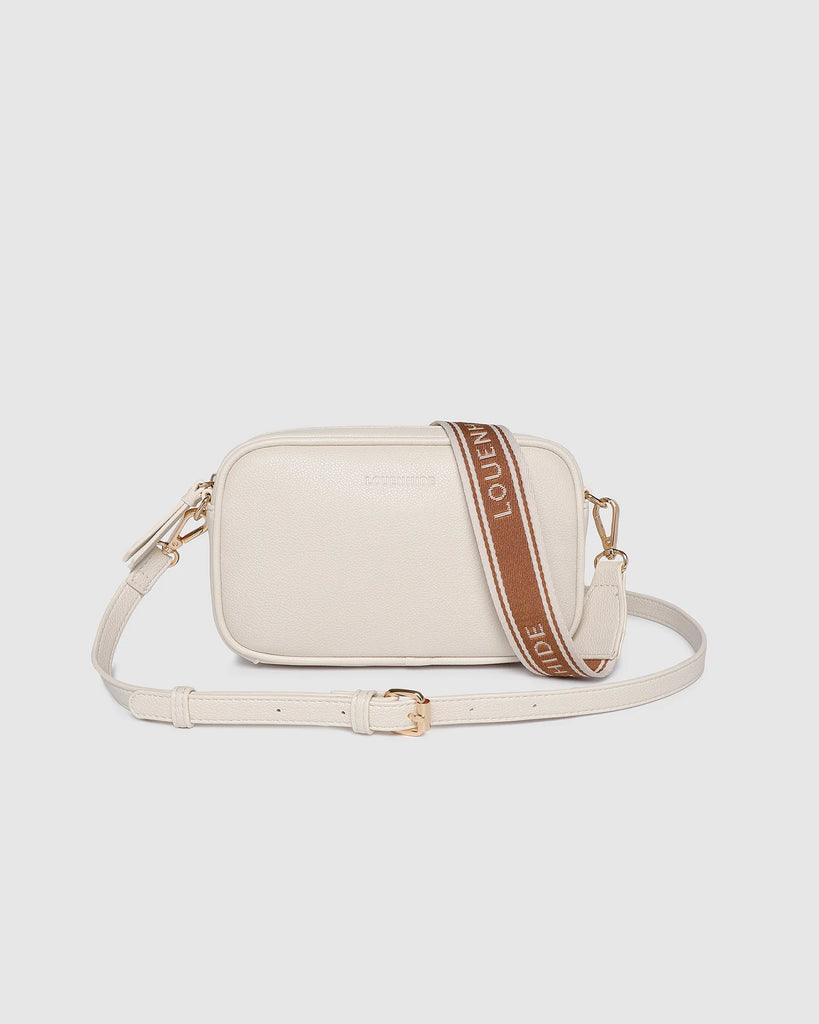 Bianca Crossbody Bag - Vanilla-Louenhide-The Bianca Vanilla Crossbody Bag is a stylish yet practical companion, thoughtfully crafted for life on the move. This women’s crossbody bag features a compact, camera-style silhouette that combines everyday functionality with timeless appeal. Made from buttery soft vegan leather and finished with light gold hardware, Bianca Vanilla brings a polished touch to casual styling. As a travel-friendly crossbody, she’s lightweight and easy to wear, with two interchangeable 