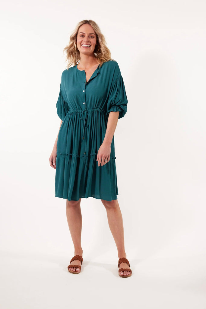 Botanical Tie Dress - Teal-Isle of Mine-The Botanical Tie Dress is the epitome of summer style. With its comfortable one-size fit and silk-like fabric, it exudes a carefree elegance. Light and airy, this dress is enhanced by the half-button front, bishop sleeves, and drawstring waist. Complete the look for your next garden party with metallic accessories and wedges. FEATURES: Round neck with half-button detail Drop shoulder Bishop sleeves Drawstring with gathering Inseam pockets Single frilled tier with gat
