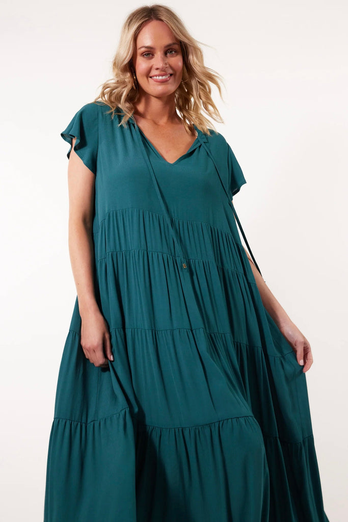 Botanical tiered dress - teal-Isle of Mine-Embrace a carefree summer with the Botanical Tiered Dress. Its flowing silhouette and luxurious silk-like fabric make it an excellent choice for day-to-day wear. Whether you pair it with sneakers or sandals, this dress offers effortless style and is perfect for a relaxed coffee meet-up with friends. FEATURES: Frilled V-neck with drawstring Short flutter sleeves Tiered with gathering Inseam pockets Maxi-length Plain Material: 100% Viscose Print Material: 100% Rayon-