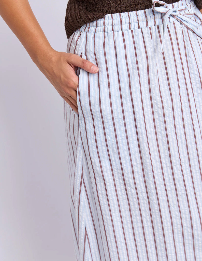 Breeze Skirt - Light Blue-Foxwood-Made for sunny days and slow weekends. The Breeze Skirt is crafted from breathable cotton with yarn dyed stripes and an easy flowing silhouette. Finished with an elastic waistband, adjustable drawcord and side pockets, it's the kind of skirt you'll keep reaching for all season long. Elastic waist with drawcord Yarn dyed stripe Side pockets Model is wearing a size 10-Pash + Evolve