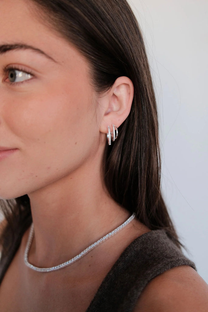Celeste Hoop - Silver-Zafino-The Celeste Hoop brings a fresh twist to a timeless silhouette. With its double-layered design and a line of sparkling crystals, this silver-tone style offers just the right balance of elegance and edge. Perfect for elevating your everyday look or adding subtle shine to evening wear, the Celeste Hoop is made to be on high rotation. Metal: Silver Rhodium Plated on BrassDimensions: 5mm (W) x 19mm HoopWater Resistant: Splash proof, not recommended to be worn in the ocean or pool Wa