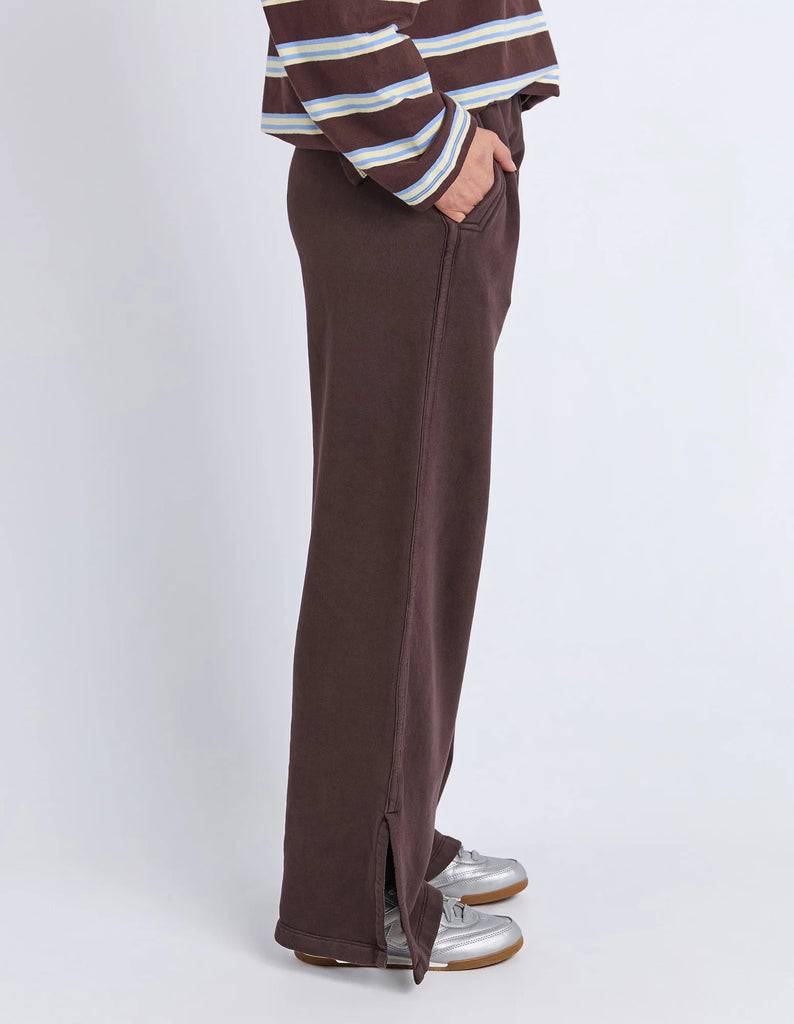 Classic Track Pant - Coffee-Foxwood-Comfort? Tick. Style? Double tick. Our Classic Track Pant is here to level up your lounge game. With an easy elastic waist, playful leg embroidery, and a straight-leg cut that feels as good as it looks—these pants are made for slow mornings and stylish strolls. Bonus points for the hem splits and pockets (because everything's better with pockets). Elastic waist Hem splits Leg embroidery 100% Cotton Our model is 176cm and wears Size 10-Pash + Evolve