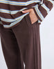 Classic Track Pant - Coffee-Foxwood-Comfort? Tick. Style? Double tick. Our Classic Track Pant is here to level up your lounge game. With an easy elastic waist, playful leg embroidery, and a straight-leg cut that feels as good as it looks—these pants are made for slow mornings and stylish strolls. Bonus points for the hem splits and pockets (because everything's better with pockets). Elastic waist Hem splits Leg embroidery 100% Cotton Our model is 176cm and wears Size 10-Pash + Evolve