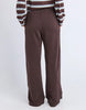 Classic Track Pant - Coffee-Foxwood-Comfort? Tick. Style? Double tick. Our Classic Track Pant is here to level up your lounge game. With an easy elastic waist, playful leg embroidery, and a straight-leg cut that feels as good as it looks—these pants are made for slow mornings and stylish strolls. Bonus points for the hem splits and pockets (because everything's better with pockets). Elastic waist Hem splits Leg embroidery 100% Cotton Our model is 176cm and wears Size 10-Pash + Evolve