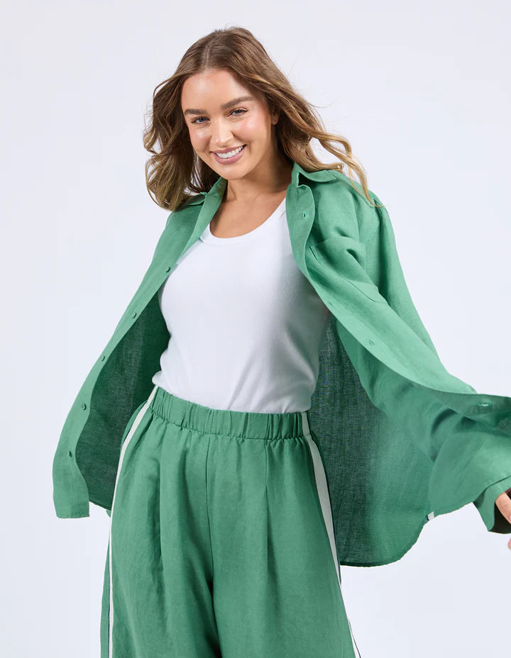 Elemental Shirt - Green-Foxwood-The Elemental Shirt blends laid-back style with a sporty edge. Made from a breathable linen blend, it features classic buttons and collar, a handy chest pocket, and sleek side tape details for a modern twist. Easy to wear and made to move with you. Side tape detail Front pocket placket opening Chest pocket 55% Linen, 45% Viscose Model is wearing a size 10-Pash + Evolve