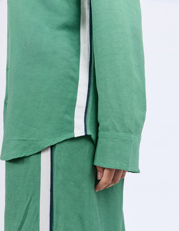 Elemental Shirt - Green-Foxwood-The Elemental Shirt blends laid-back style with a sporty edge. Made from a breathable linen blend, it features classic buttons and collar, a handy chest pocket, and sleek side tape details for a modern twist. Easy to wear and made to move with you. Side tape detail Front pocket placket opening Chest pocket 55% Linen, 45% Viscose Model is wearing a size 10-Pash + Evolve