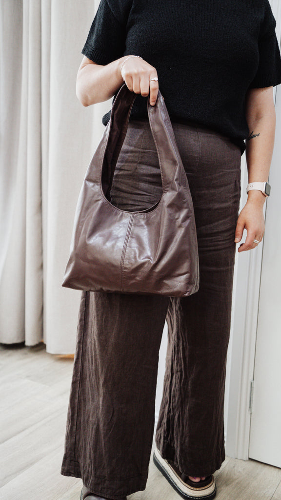 Elle shoulder bag - chocolate-Baleka Leather-Timelessly stylish, Elle is your go to for days that flow from brunch to evening drinks with the girls. With a sleek, minimal silhouette that fits comfortably under the arm, it's the perfect blend of style and ease. Featuring a secure button closure, internal zip, slip pocket and a fully lined interior, the Elle bag carries your essentials with refined simplicity. Understated, modern and ready for wherever the day takes you! A stylish bag designed in the beautifu