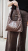 Elle shoulder bag - chocolate-Baleka Leather-Timelessly stylish, Elle is your go to for days that flow from brunch to evening drinks with the girls. With a sleek, minimal silhouette that fits comfortably under the arm, it's the perfect blend of style and ease. Featuring a secure button closure, internal zip, slip pocket and a fully lined interior, the Elle bag carries your essentials with refined simplicity. Understated, modern and ready for wherever the day takes you! A stylish bag designed in the beautif