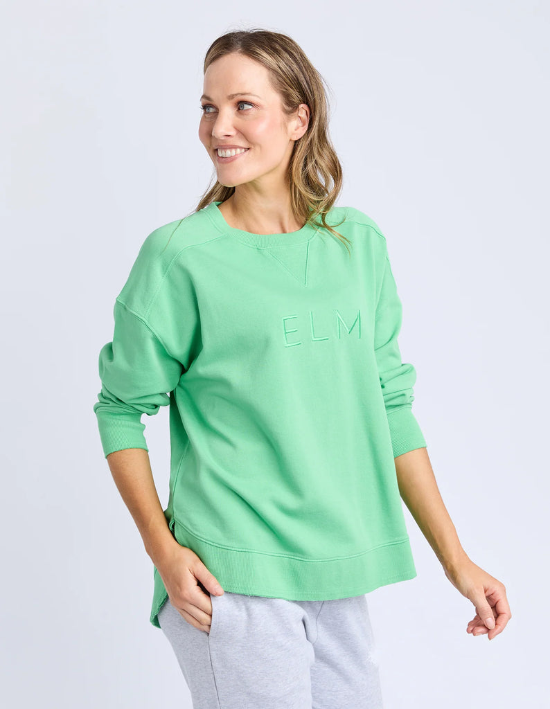 Established crew - spring green-Elm-Guaranteed to be your new favourite crew. The Established Crew features raw seam detail and cute Elm embroidery making it an effortless choice for both comfort and style. Raw Seams Elm Embroidery Crew Neckline Unbrushed Cotton Fleece 100% Cotton Model is wearing a size 10-Pash + Evolve
