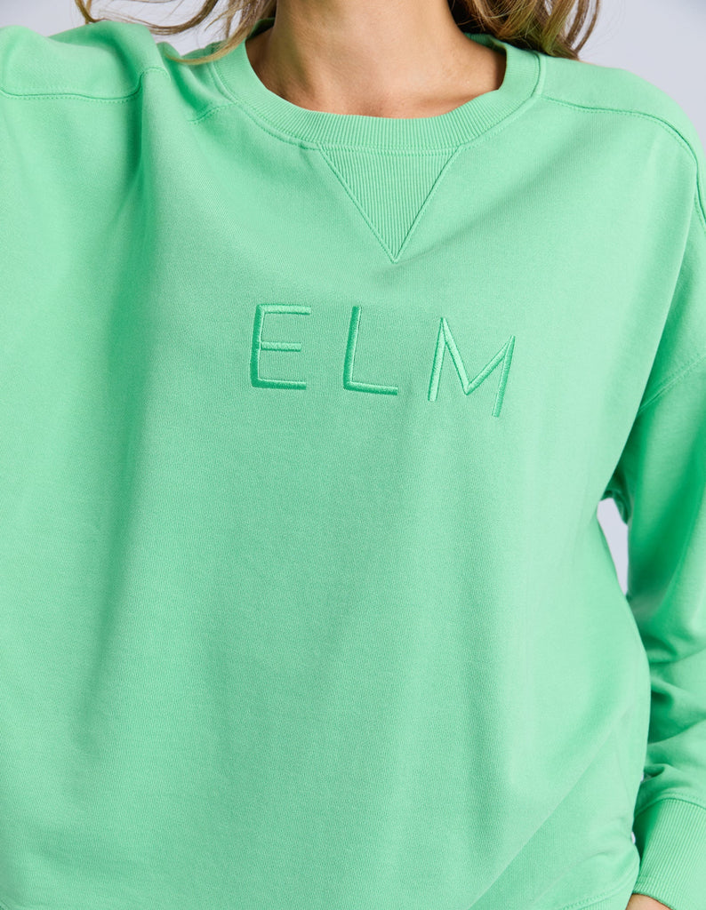 Established crew - spring green-Elm-Guaranteed to be your new favourite crew. The Established Crew features raw seam detail and cute Elm embroidery making it an effortless choice for both comfort and style. Raw Seams Elm Embroidery Crew Neckline Unbrushed Cotton Fleece 100% Cotton Model is wearing a size 10-Pash + Evolve