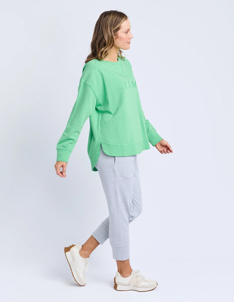 Established crew - spring green-Elm-Guaranteed to be your new favourite crew. The Established Crew features raw seam detail and cute Elm embroidery making it an effortless choice for both comfort and style. Raw Seams Elm Embroidery Crew Neckline Unbrushed Cotton Fleece 100% Cotton Model is wearing a size 10-Pash + Evolve