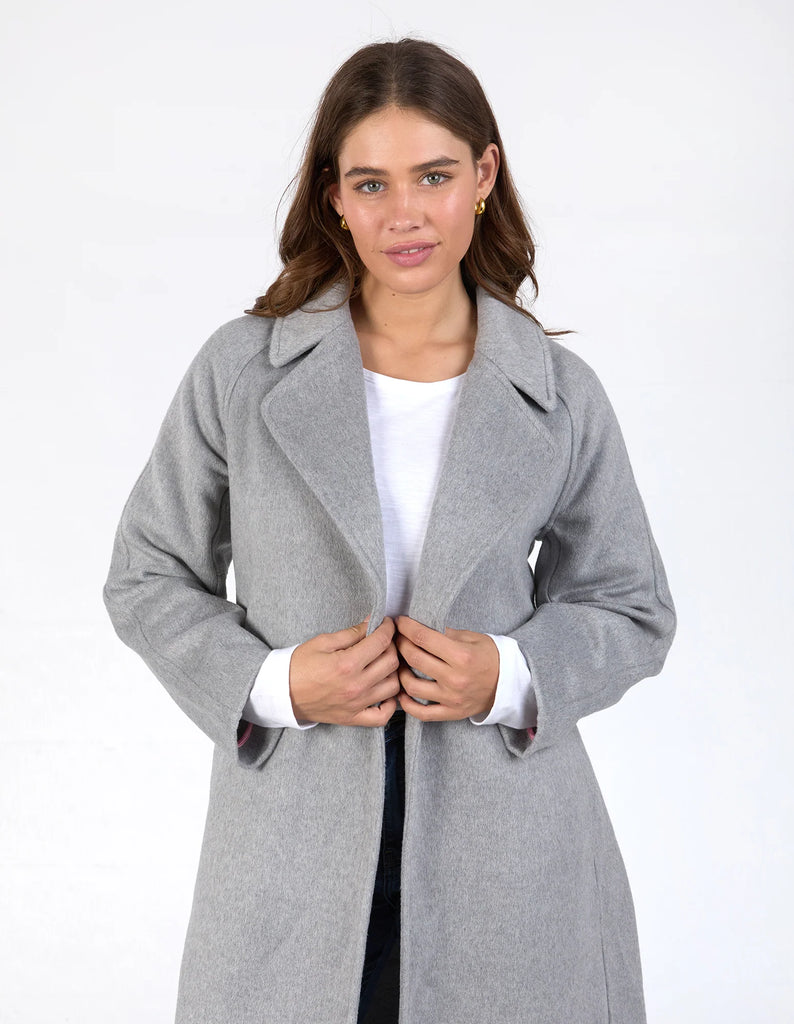 Farrah coat - grey marle-Elm-A coat for the ages. This gorgeous wool melton blend coat features a endlessly flattering long line shape with button openings and lapel collar. The jacket has pockets and is not lined making it versatile for all weather. Long line shape Button opening with pockets No lining 90% Polyester, 10% Wool Model is wearing a size 10-Pash + Evolve