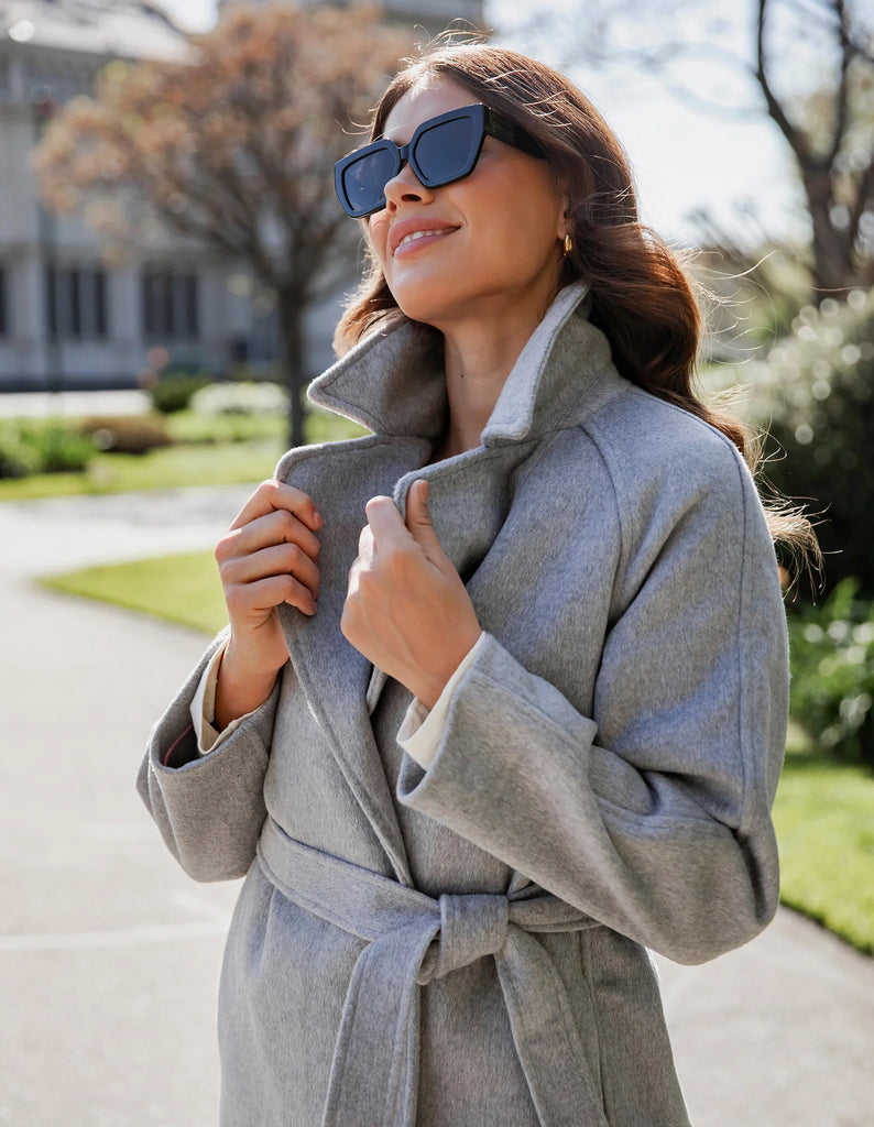 Farrah coat - grey marle-Elm-A coat for the ages. This gorgeous wool melton blend coat features a endlessly flattering long line shape with button openings and lapel collar. The jacket has pockets and is not lined making it versatile for all weather. Long line shape Button opening with pockets No lining 90% Polyester, 10% Wool Model is wearing a size 10-Pash + Evolve