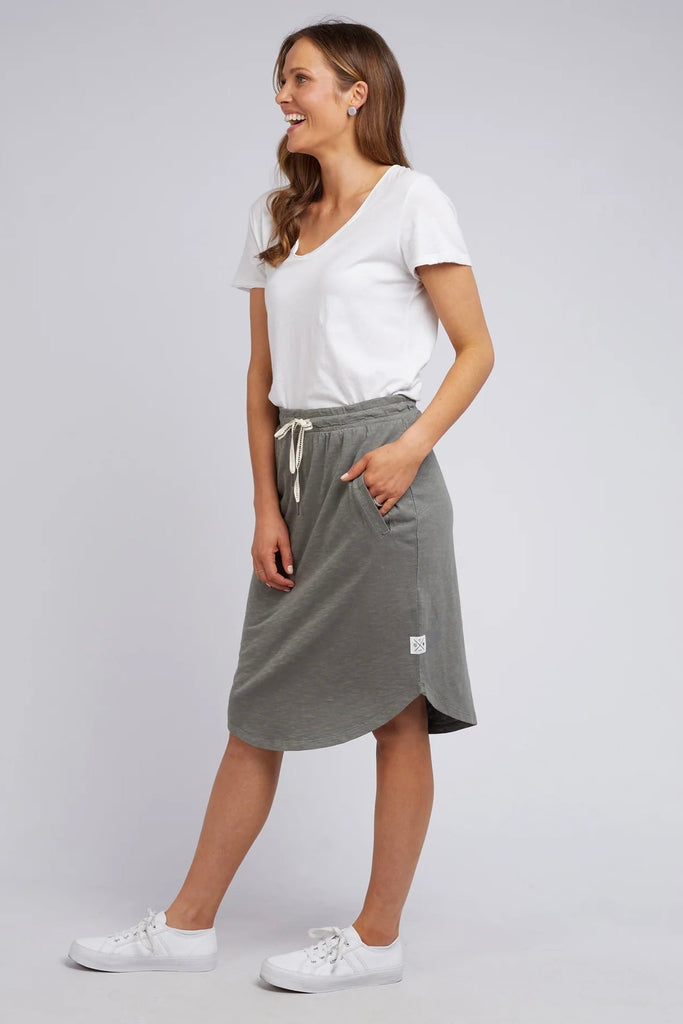 Fundamental Isla Skirt - Khaki-Elm-Stylish And Versatile Skirt Ideal For Everyday Spring & Summer Wear. Featuring An Elasticated Tie Waist, Pockets And A Below Knee Scooped Hemline, The Isla Skirt Is Ideal For Everyone's Wardrobe. Versatile Everyday Skirt Elasticated Tie Waist Scooped Hemline Cotton Jersey Model is 169cm and wears Size 10-Pash + Evolve