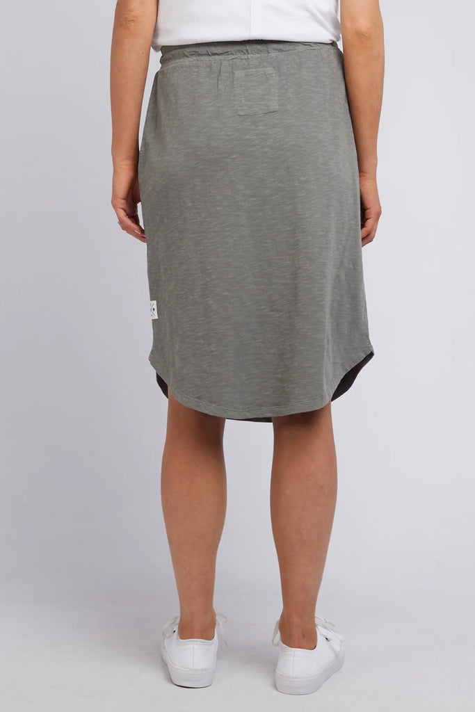 Fundamental Isla Skirt - Khaki-Elm-Stylish And Versatile Skirt Ideal For Everyday Spring & Summer Wear. Featuring An Elasticated Tie Waist, Pockets And A Below Knee Scooped Hemline, The Isla Skirt Is Ideal For Everyone's Wardrobe. Versatile Everyday Skirt Elasticated Tie Waist Scooped Hemline Cotton Jersey Model is 169cm and wears Size 10-Pash + Evolve