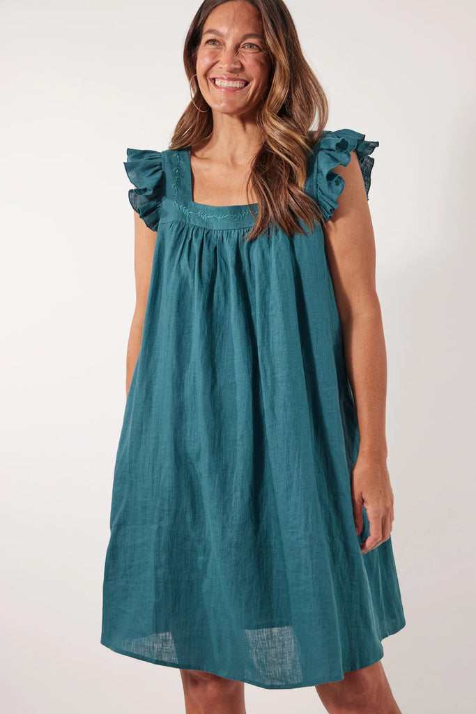 Gala Dress - Teal-Isle of Mine-Exude grace and confidence with the elegant Gala Dress, made from an airy Ramie fabric. Delicate embroidery adorns the square neckline, complemented by charming frill sleeves and a relaxed hem. Transition seamlessly from day to night by pairing it with sneakers or strappy sandals. FEATURES: Square neck with embroidered detail and gathering Short frill sleeves Inseam pockets Knee-length Relaxed hem Lotus, Peony & Teal: 100% Ramie Canvas: 52% Linen, 48% Ramie Lining: 100% Rayon-
