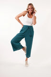 Gala Pant - Teal-Isle of Mine-Step into comfort and style with the Gala Pant, crafted with a luxurious Ramie fabric. The elastic waist and drawstring offer a perfect fit, while the loose, flowy, and breezy design adds a touch of effortless elegance. Match them with a Ramie blouse and sandals for a sleek and contemporary look. FEATURES: Elastic waist with drawstring and tassel Inseam pockets Wide flare Ankle-length Lotus, Peony & Teal: 100% Ramie Canvas: 52% Linen, 48% Ramie Lotus Only Lining: 100% Rayon Tas