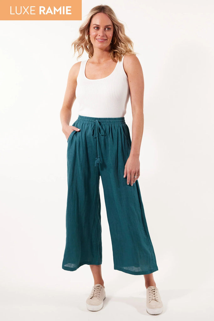 Gala Pant - Teal-Isle of Mine-Step into comfort and style with the Gala Pant, crafted with a luxurious Ramie fabric. The elastic waist and drawstring offer a perfect fit, while the loose, flowy, and breezy design adds a touch of effortless elegance. Match them with a Ramie blouse and sandals for a sleek and contemporary look. FEATURES: Elastic waist with drawstring and tassel Inseam pockets Wide flare Ankle-length Lotus, Peony & Teal: 100% Ramie Canvas: 52% Linen, 48% Ramie Lotus Only Lining: 100% Rayon Tas