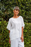 Gala Relax Top - Lotus-Isle of Mine-The one-size Gala Relax Top is a perfect addition to your everyday wardrobe. Crafted with Ramie, it offers a lightweight and airy fit, ideal for the warmer season. With its round neck, elbow-length sleeves, and delicate embroidered detailing, it exudes effortless style. Pair it with Ramie shorts or trousers for an effortless, all-natural look. FEATURES: Round neck Elbow-length with embroidered detail Side vents Relaxed fit Lotus, Peony & Teal: 100% Ramie Canvas: 52% Linen
