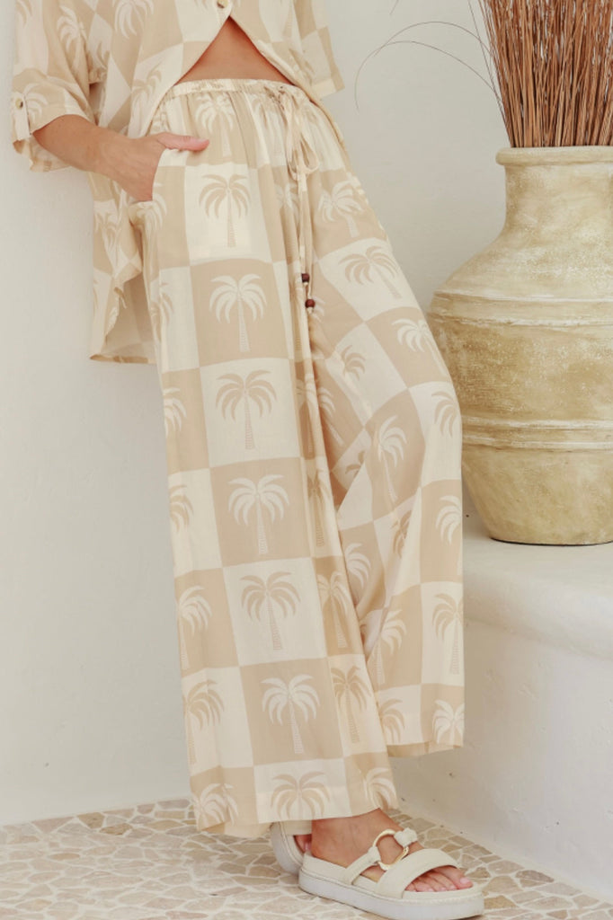 Halsey palm wide leg pant - latte-Pash + Evolve-Our beautiful Halsey wide leg pant features the cutest palm print. These pants are so soft and are made from a lightweight material, perfect for those warmer Summer days. Simply wear with a plain coloured top of pair back with our Halsey palm shirt for a super cute matching set. *Wide leg *Elasticated waistband *Palm print all over-Pash + Evolve