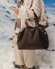 Hampton Tote Bag - Chocolate-Louenhide-The Hampton Chocolate Tote Bag is designed for departures both planned and unexpected. With a silhouette that balances structure and softness, she brings a refined presence to moments in motion, from weekend escapes to daily commutes. Crafted in smooth vegan leather, Hampton Chocolate features dual top handles and a detachable strap, offering a versatile, considered way to carry. Understated in finish, she redefines the carry-on tote bag with trolley sleeve, moving ef