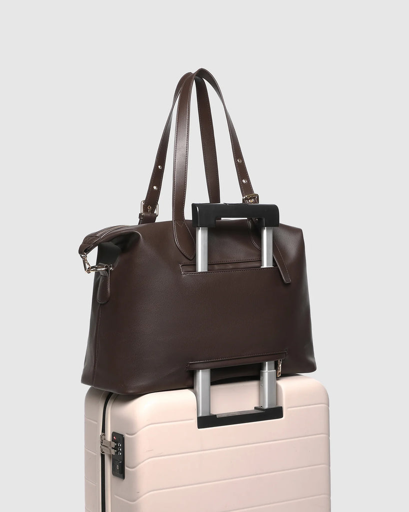 Hampton Tote Bag - Chocolate-Louenhide-The Hampton Chocolate Tote Bag is designed for departures both planned and unexpected. With a silhouette that balances structure and softness, she brings a refined presence to moments in motion, from weekend escapes to daily commutes. Crafted in smooth vegan leather, Hampton Chocolate features dual top handles and a detachable strap, offering a versatile, considered way to carry. Understated in finish, she redefines the carry-on tote bag with trolley sleeve, moving eff