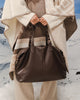Hampton Tote Bag - Chocolate-Louenhide-The Hampton Chocolate Tote Bag is designed for departures both planned and unexpected. With a silhouette that balances structure and softness, she brings a refined presence to moments in motion, from weekend escapes to daily commutes. Crafted in smooth vegan leather, Hampton Chocolate features dual top handles and a detachable strap, offering a versatile, considered way to carry. Understated in finish, she redefines the carry-on tote bag with trolley sleeve, moving ef