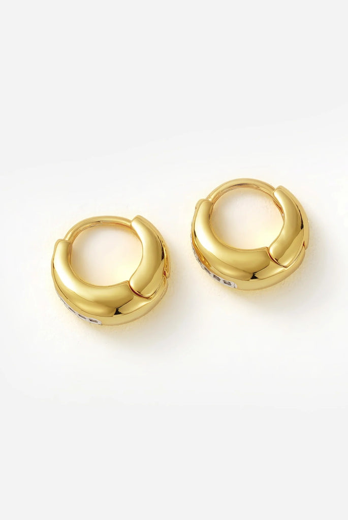 Hayley Huggie - Gold-Zafino-The Hayley Huggie combines a sleek gold silhouette with a line of sparkling crystals for effortless sophistication. Its curved design hugs the ear comfortably, making it the perfect everyday piece that transitions seamlessly from casual to occasion wear. Wear solo for a subtle shine or stack with other huggies and studs for a layered look.Designed for modern women who want effortless style, every day. Metal: 18K Gold Plated on BrassDimensions: 10mm HoopWater Resistant: Splash pro