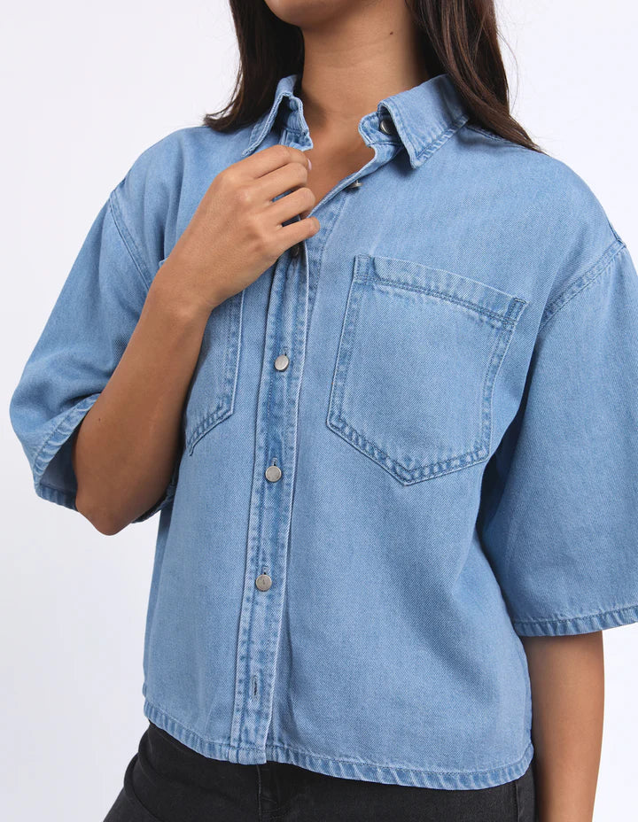 Hutton Denim Shirt - Light Blue-Foxwood-Effortlessly cool and versatile, this short-sleeve denim shirt is a wardrobe must-have. Made from 100% cotton, it offers a soft, breathable feel with a classic look. Featuring a front button opening and a relaxed fit, it’s perfect for layering or wearing on its own Front button opening Short sleeve Front chest pockets 100% Cotton-Pash + Evolve