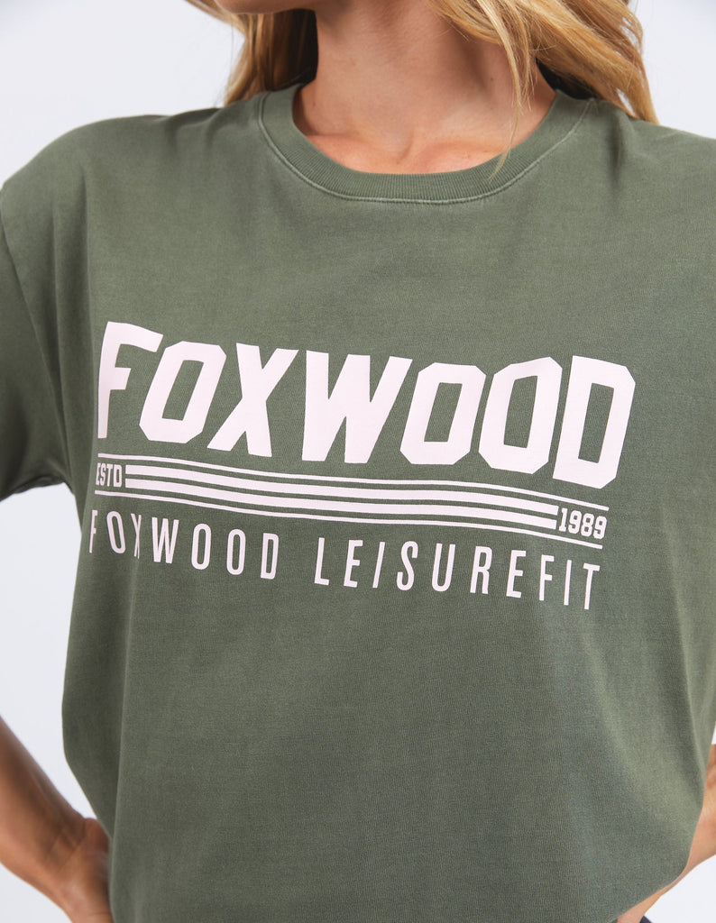 Impact Tee - Olive Green-Foxwood-Sporty & fun the new Impact Tee from LeisureFit is a classic 100% relaxed fitting tee that features an exclusive chest print in pink for the ultimate in colour and fun this season. Round neckline Foxwood exclusive front chest print Relaxed fit 100% Cotton Our model is 176cm and wears Size 10-Pash + Evolve