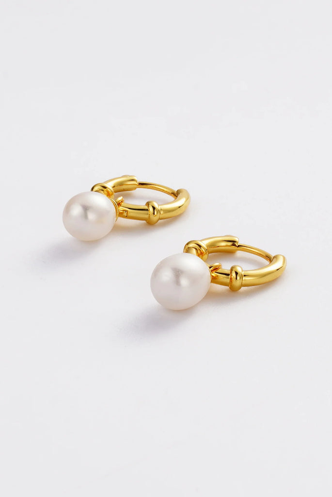 Ivy Mini Drop - Gold-Zafino-A delicate twist on the classic huggie, the Ivy Mini Drop features a petite crystal cluster charm that catches the light with every movement. Feminine and versatile, these earrings are perfect for layering with studs and hoops or wearing solo for a subtle sparkle. A timeless style you’ll love for both everyday and occasion wear. Metal: 18K Gold Plated on BrassDimensions: 8mm Huggie, 20mm Drop mm x 8mmWater Resistant: Splash proof, not recommended to be worn in the ocean or pool W