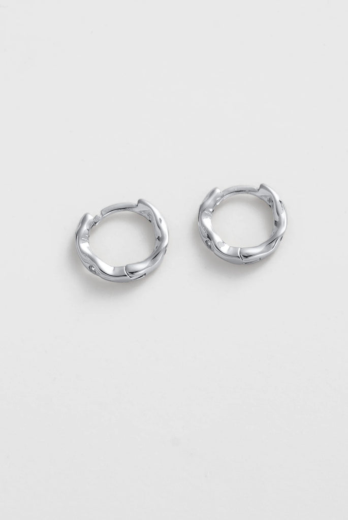 June Huggie - Silver-Zafino-The June Huggie features a softly sculpted organic silhouette with delicate crystal accents set into a polished gold finish. Its fluid shape adds subtle texture and dimension, giving this everyday huggie a modern and distinctive edge. Designed to sit close to the ear, June is perfect worn alone for a refined look or stacked with other earrings for a curated ear style. Metal: 18K gold plated on brass base Dimensions: 11mm outer diameter, 7.4mm inner diameter + 2.2mm width Water Re