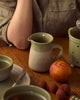 Kitchen Life Jug - Peppercorn-Robert gordon-Inspired by the steady rhythm of the kitchen, this collection celebrates the beauty of daily preparation and time spent cooking. Subtle glazes and gentle leaf embellishment introduce softness and balance to everyday cooking, finished in a reactive glaze with delicate speckling. Made from stoneware Microwave & Dishwasher safe Earthy clay body with green reactive glaze 540ml | 12cm Designed in Australia-Pash + Evolve