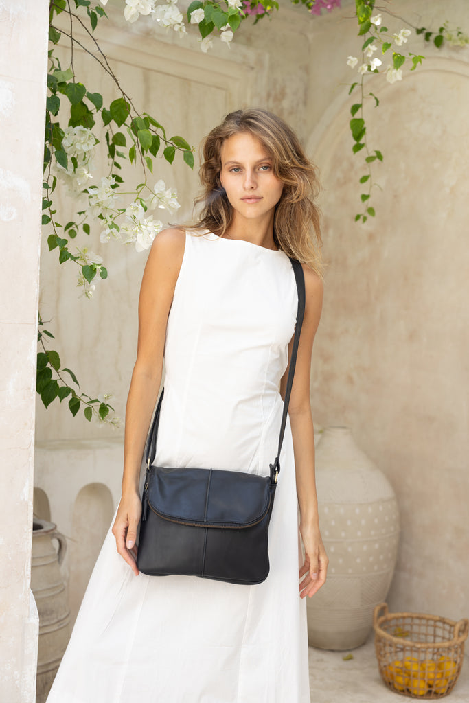 Lexci bag - Black-Baleka Leather-Defined by minimalistic elegance, the Lexci bag features a sleek foldover silhouette with thoughtful details. A secure zip closure, discreet back zip pocket and two sophisticated compartments - including a front section with an internal zip and pockets for seamless organisation. Fully lined and designed for versatility, the adjustable strap lets you wear it crossbody or over the shoulder with effortless ease - Lexci is your everyday essential! A versatile and minimalistic ba