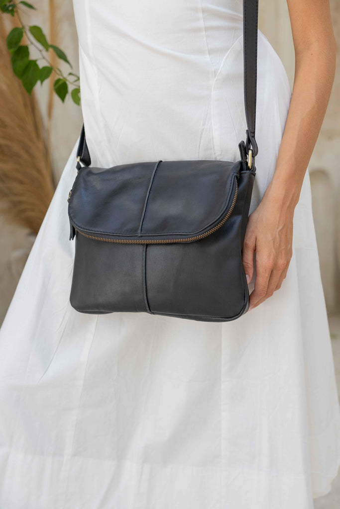 Lexci bag - Black-Baleka Leather-Defined by minimalistic elegance, the Lexci bag features a sleek foldover silhouette with thoughtful details. A secure zip closure, discreet back zip pocket and two sophisticated compartments - including a front section with an internal zip and pockets for seamless organisation. Fully lined and designed for versatility, the adjustable strap lets you wear it crossbody or over the shoulder with effortless ease - Lexci is your everyday essential! A versatile and minimalistic ba