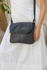Lexci bag - Black-Baleka Leather-Defined by minimalistic elegance, the Lexci bag features a sleek foldover silhouette with thoughtful details. A secure zip closure, discreet back zip pocket and two sophisticated compartments - including a front section with an internal zip and pockets for seamless organisation. Fully lined and designed for versatility, the adjustable strap lets you wear it crossbody or over the shoulder with effortless ease - Lexci is your everyday essential! A versatile and minimalistic b