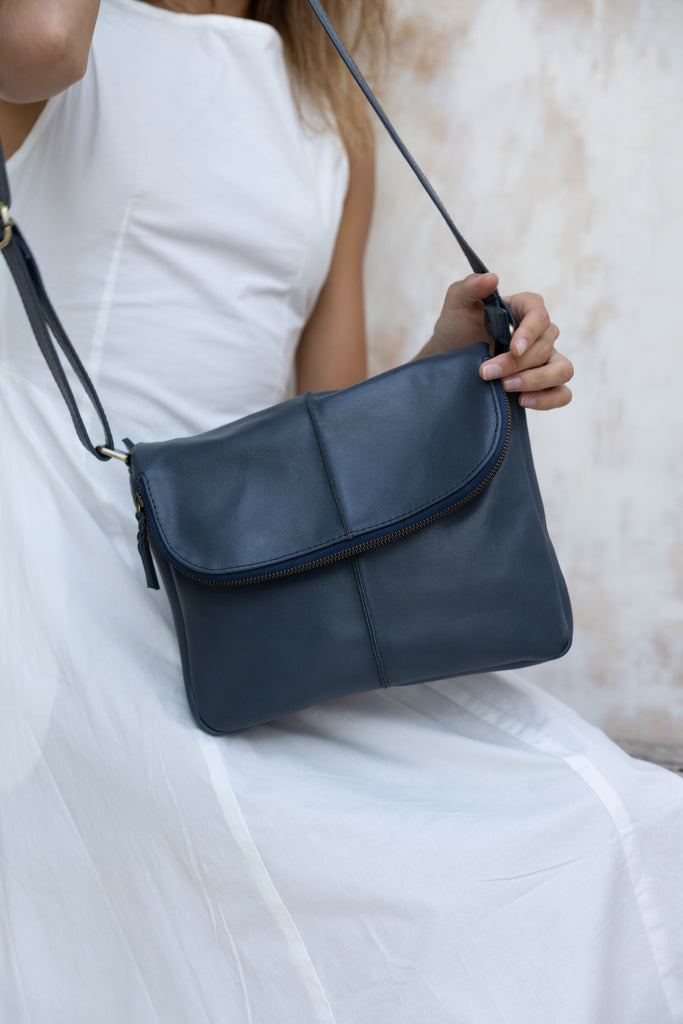 Lexci bag - Navy Blue-Baleka Leather-Defined by minimalistic elegance, the Lexci bag features a sleek foldover silhouette with thoughtful details. A secure zip closure, discreet back zip pocket and two sophisticated compartments - including a front section with an internal zip and pockets for seamless organisation. Fully lined and designed for versatility, the adjustable strap lets you wear it crossbody or over the shoulder with effortless ease - Lexci is your everyday essential! A versatile and minimalisti