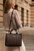 Manhattan Tote Bag - Chocolate-Louenhide-The Louenhide Manhattan Chocolate Tote Bag is a minimalist style work bag in a range of classic and statement colourways. With beautiful top stitched exterior trims and statement handles, this functional bag has ample interior space for all your office essentials. Easily take this tote bag from day to night with the smart polyurethane vegan exterior matched with the colourful contrast nylon lining, this mid-sized tote is great for work or play. This versatile style c