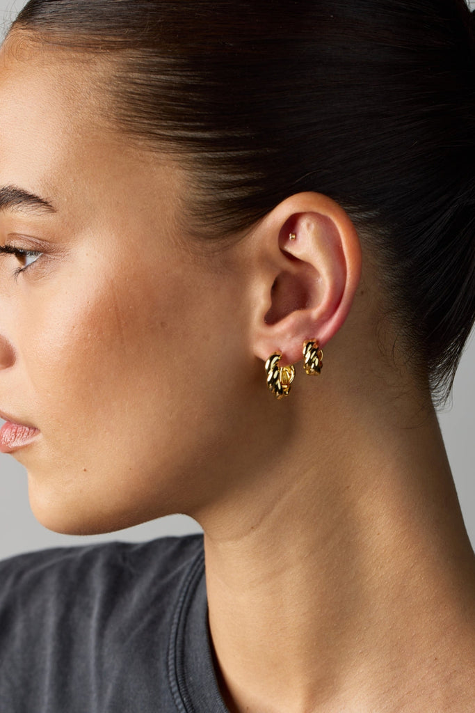 Maya hoop - gold-Zafino-Featuring a unique twist design, these hoops offer a modern yet timeless appeal, perfect for stacking or wearing solo. Their sleek silhouette and lightweight feel make them an essential addition to your jewellery collection. Metal: 18K Gold Plated on BrassDimensions: 5mm x 17mm Waterproof-Pash + Evolve