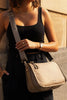 Milan Nylon Crossbody Bag - Beige-Louenhide-The Louenhide Milan Beige Nylon Crossbody Bag effortlessly combines an elevated minimal aesthetic with everyday functionality. This stylish, convertible crossbody bag features an adjustable and detachable sateen guitar strap and a comfortable vegan leather shoulder strap, which tucks securely under the bag with a press stud closure when not in use. Lightweight and durable, the nylon material compliments an urban, street style aesthetic while remaining reliable for