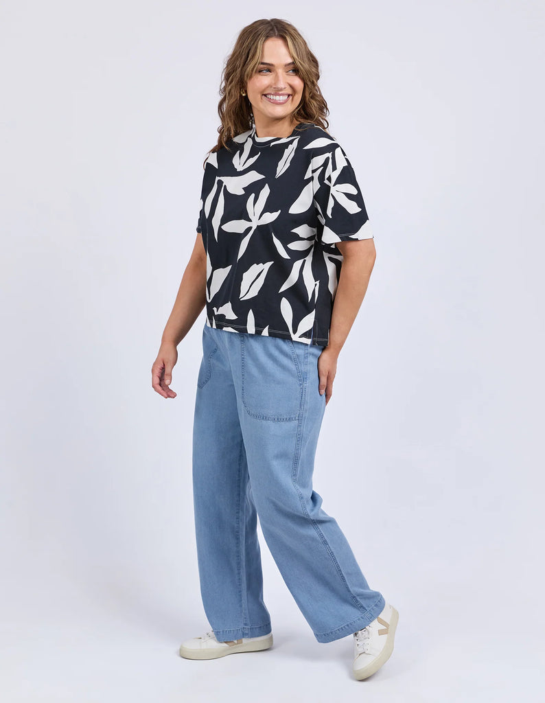 Mimosa Tee - Black Print-Elm-Redefine comfort and chic with the Mimosa Tee, made for layering or wearing solo. This piece is pure Elm: playful, polished, and practical. Exclusive Elm print Slide Splits Drop shoulder Organic Cotton Jersey Model is 171cm and wears Size 10-Pash + Evolve