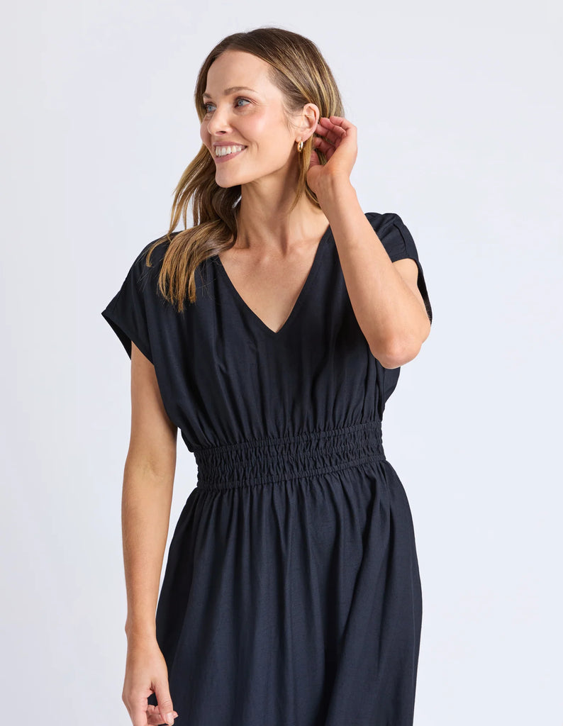 Misty Dress - Navy-Elm-The Misty Dress is crafted from a breathable linen blend, perfect for comfort and durability. Featuring an elastic waist, it offers a flattering, adaptable fit, while the midi length provides timeless elegance suitable for various occasions. Expertly designed, this dress combines practicality with refined style for a sophisticated addition to your wardrobe. Elastic waist Mid length Linen blend 30% linen 70% viscose Model is 171cm and wears Size 10-Pash + Evolve