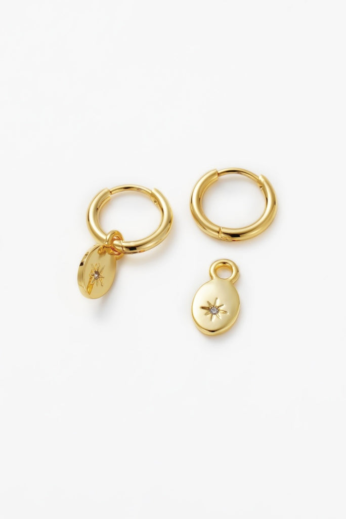 Nala hoop - gold-Zafino-A stunning and addition to your jewellery collection. These earrings feature a beautiful disk charm with a sparkling crystal star in the centre that adds a touch of magic to your look. Made with high-quality materials and attention to detail, the Nala Earring is both durable and captivating. With their comfortable fit and easy-to-wear closure, they are perfect for everyday wear or special occasions. Metal: 18K Gold Plated on BrassDimensions: 10mm HoopWater Resistant: Splash proof, n