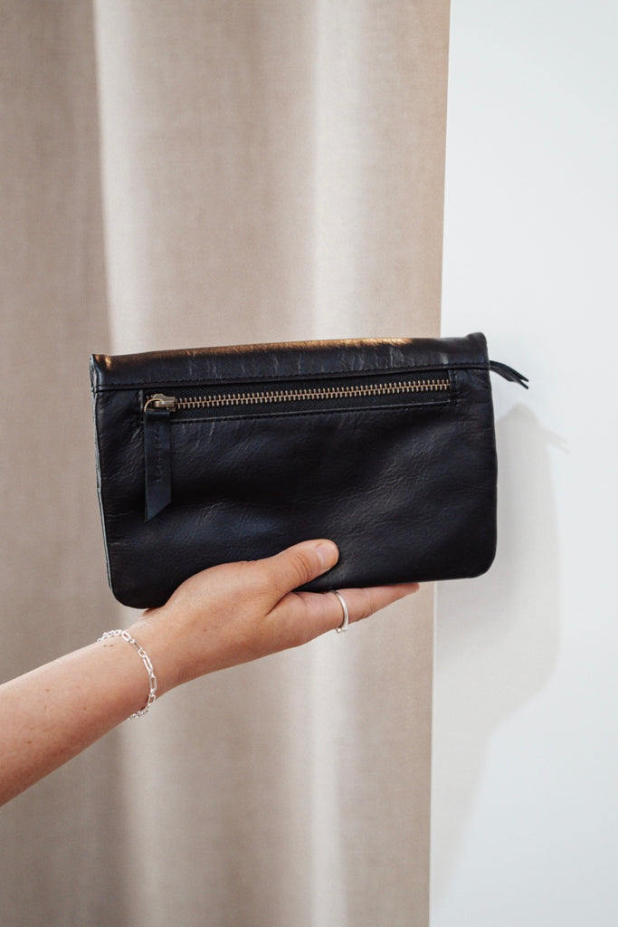 Noa wallet - black-Baleka Leather-Sleek, functional, and effortlessly modern — the Noa Wallet is designed to keep your essentials beautifully organized. It features a magnetic closure for a smooth, secure snap and a back zip pocket for quick-access items. Inside, you’ll find a thoughtfully designed layout with an internal zip compartment, 2 note dividers, and 16 card slots The Noa Wallet combines practicality with a minimalist aesthetic, making it the perfect accessory for wherever your day takes you. Magne