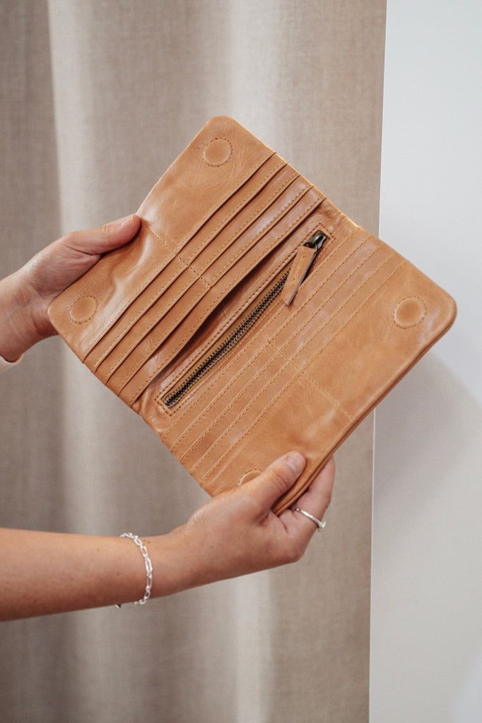 Noa wallet - tan-Baleka Leather-Sleek, functional, and effortlessly modern — the Noa Wallet is designed to keep your essentials beautifully organized. It features a magnetic closure for a smooth, secure snap and a back zip pocket for quick-access items. Inside, you’ll find a thoughtfully designed layout with an internal zip compartment, 2 note dividers, and 16 card slots The Noa Wallet combines practicality with a minimalist aesthetic, making it the perfect accessory for wherever your day takes you. Magneti