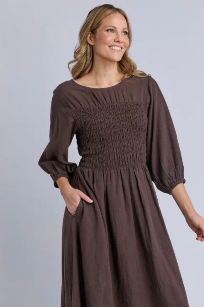 Nora shirred dress - chocolate-Elm-The Nora Shirred Dress is an easy throw-on style that balances comfort with a polished, everyday feel. Finished with trending brown colour way, elasticated bust, elastic cuff, it's designed to feel as good as it looks. Crafted from a breathable linen-viscose blend, it delivers comfortable wear and easy versatility. Style it with boots and a cosy outer layer when the weather cools, or keep it simple with sneakers for an easy one-and-done outfit. *Elasticated bust *Elastic 