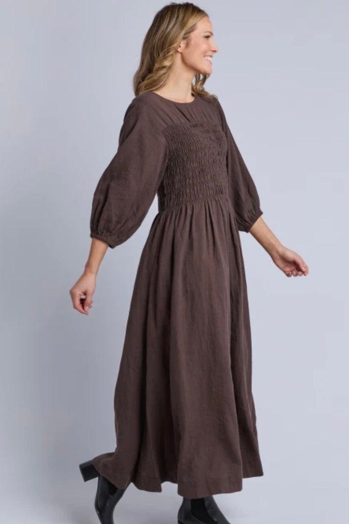 Nora shirred dress - chocolate-Elm-The Nora Shirred Dress is an easy throw-on style that balances comfort with a polished, everyday feel. Finished with trending brown colour way, elasticated bust, elastic cuff, it's designed to feel as good as it looks. Crafted from a breathable linen-viscose blend, it delivers comfortable wear and easy versatility. Style it with boots and a cosy outer layer when the weather cools, or keep it simple with sneakers for an easy one-and-done outfit. *Elasticated bust *Elastic 