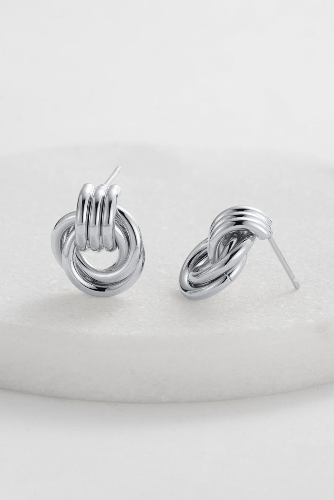 Poppy earring - Silver-Zafino-Introducing the Poppy Earrings – chic studs with a mesmerising braided design. Combining timeless elegance and contemporary style, these lightweight earrings elevate any look. The intricately braided pattern adds sophistication to your ensemble, making the Poppy Earrings your go-to for understated charm on any occasion. Metal: Silver Rhodium Plated on BrassDimensions: 14mm x 17mmWater Resistant: Splash proof, not recommended to be worn in the ocean or pool-Pash + Evolve