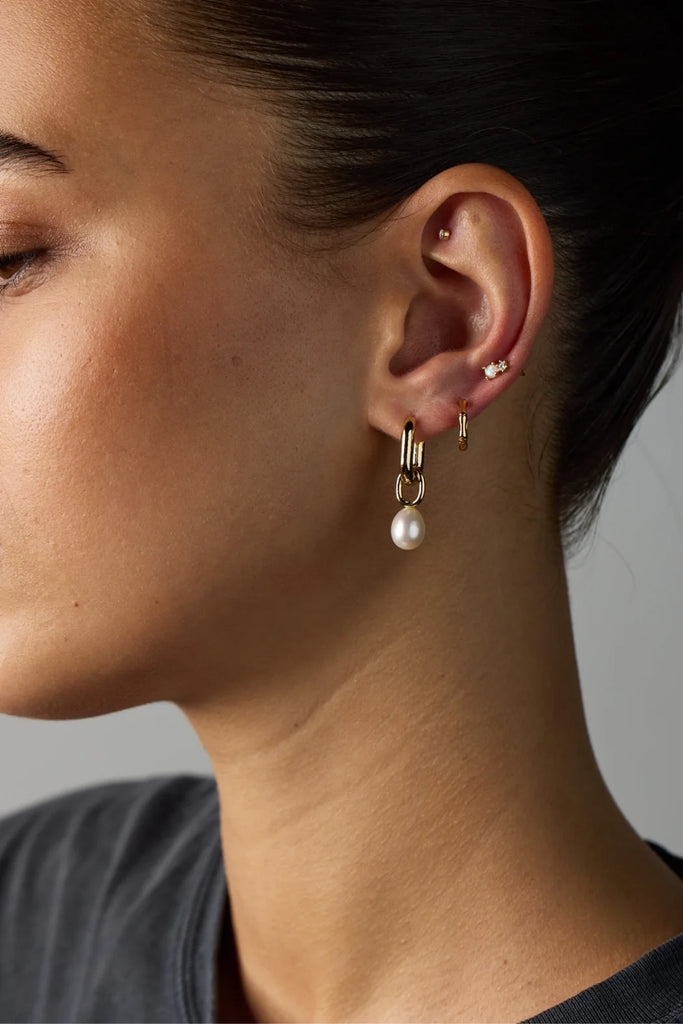 Prue Earring - Silver-Zafino-These earrings feature a stunning freshwater pearl gracefully hanging from a gold oval hoop, creating an elegant and refined design.The combination of the radiant pearl and the sleek gold oval hoop creates a perfect harmony of classic and modern aesthetics. Metal: Silver Rhodium Plated on BrassDimensions: 7mm x 30mmWater Resistant: Splash proof, not recommended to be worn in the ocean or pool Water resistant Hypoallergenic & Nickel Free Female Founded & Family Owned-Pash + Evolv