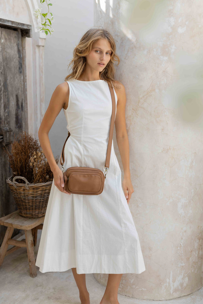 Remi crossbody bag - Camel brown Pebble-Baleka Leather-Chic, compact & endlessly versatile. The Remi is our most versatile and practical bag - thoughtfully designed to keep up with your day. Featuring a front compartment for your must-have essentials, a sleek back pocket with secure press stud closure and a spacious main compartment complete with an internal zip pocket and slip pocket for a neat interior layout. Fully lined and finished with an adjustable strap that can be worn on the shoulder or crossbody,